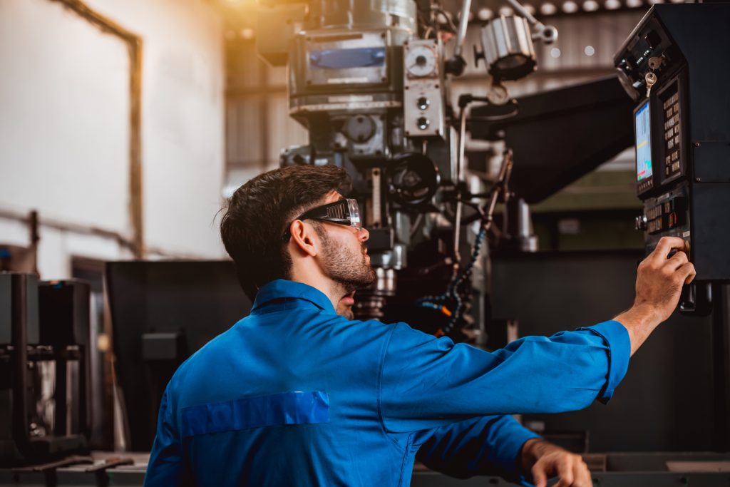 1920-industry-engineering-wearing-safety-uniform-control-operating-lathe-grinding-machine-working-in-industry-factory